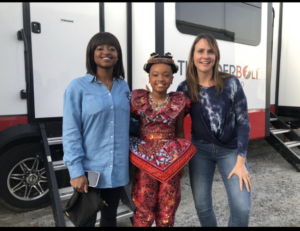 Akiley Love as Tinashe" in Coming 2 America (2020) with her mom and Kelly Young-Silva
